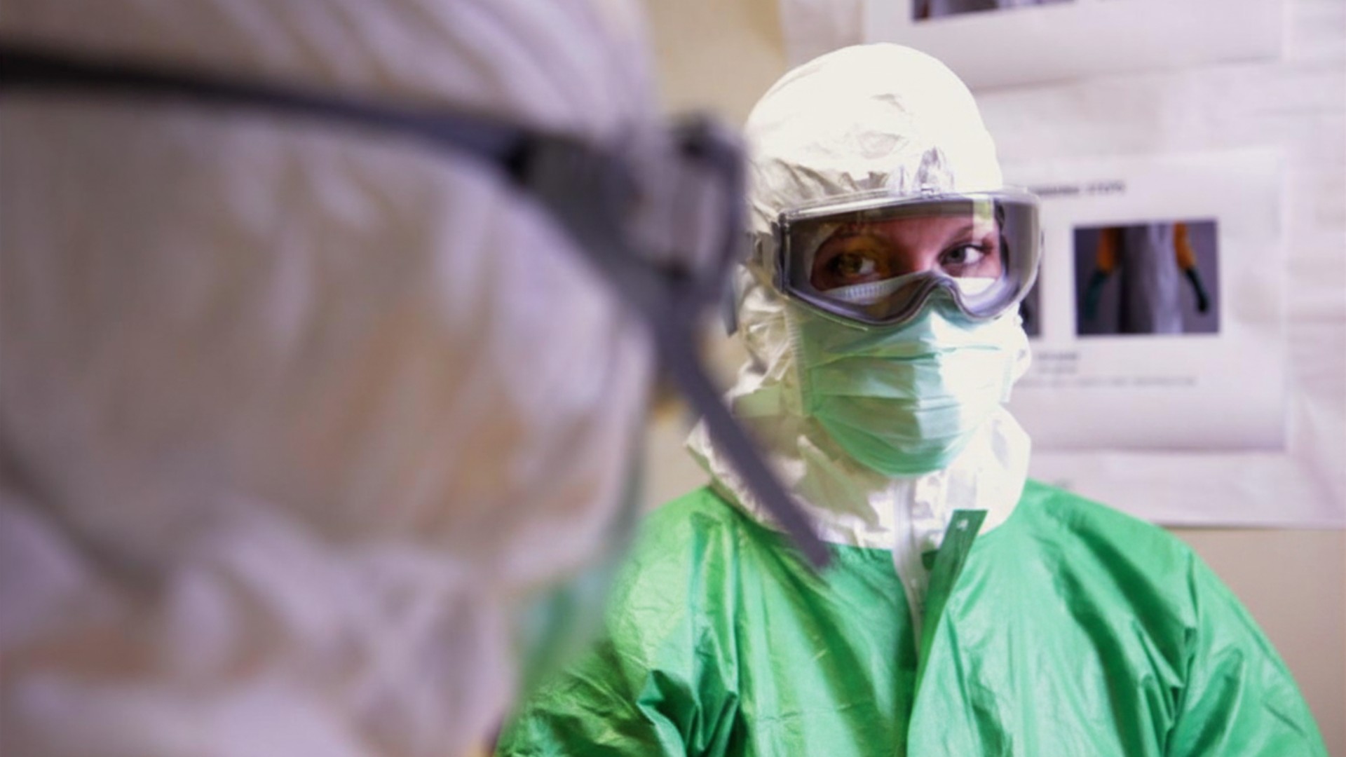 Health researcher in protective gear and N95 respirator during Ebola outbreak clinical research